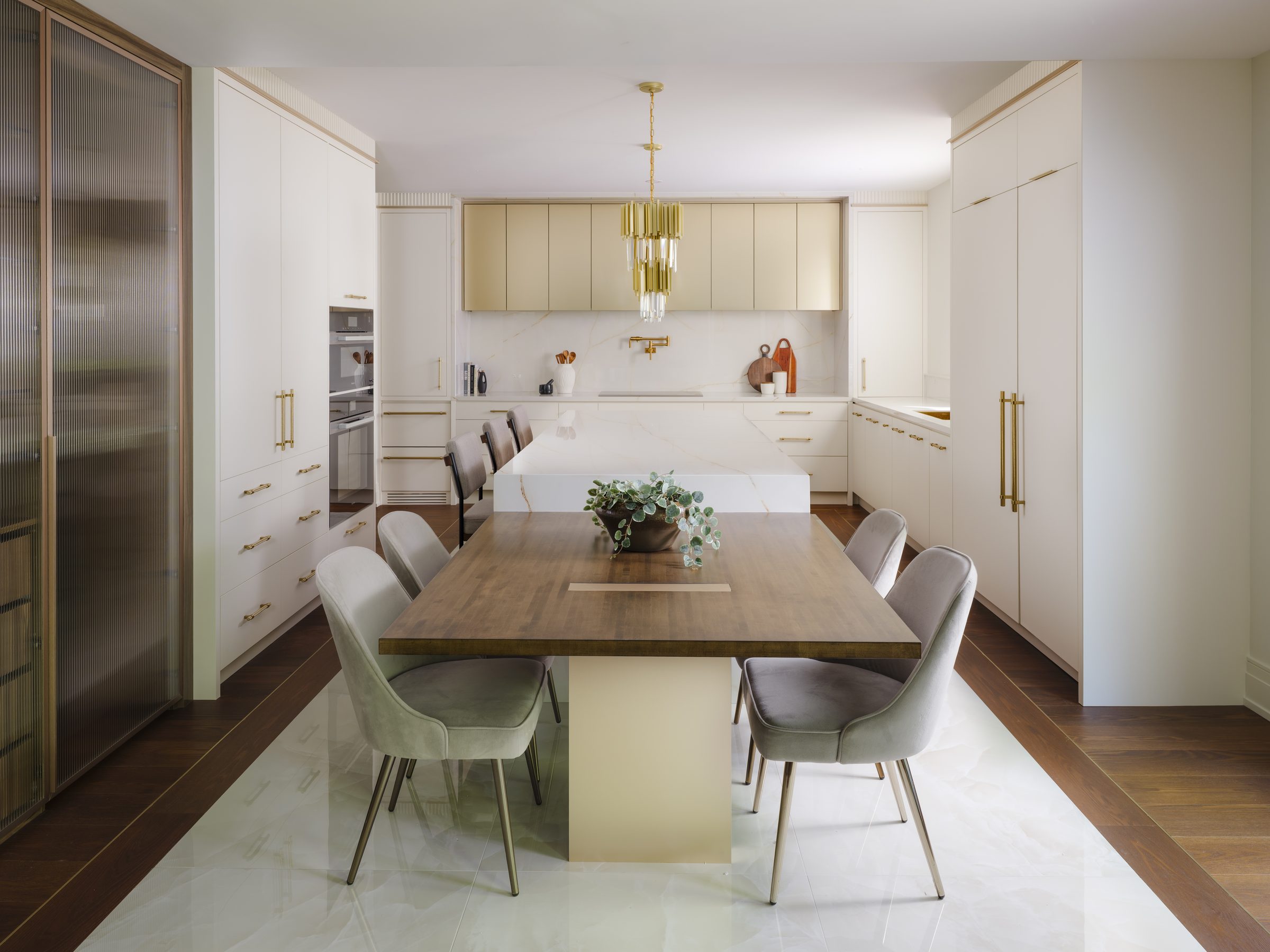 Stone, walnut and light — kitchen and dining drawn as one